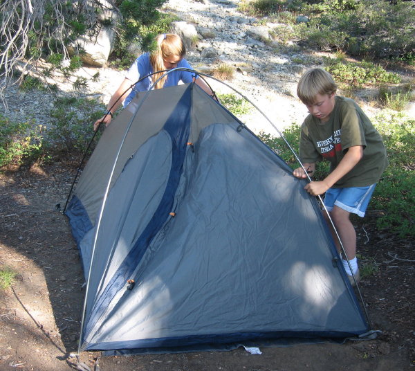 Pitching the tent takes some sibling teamwork