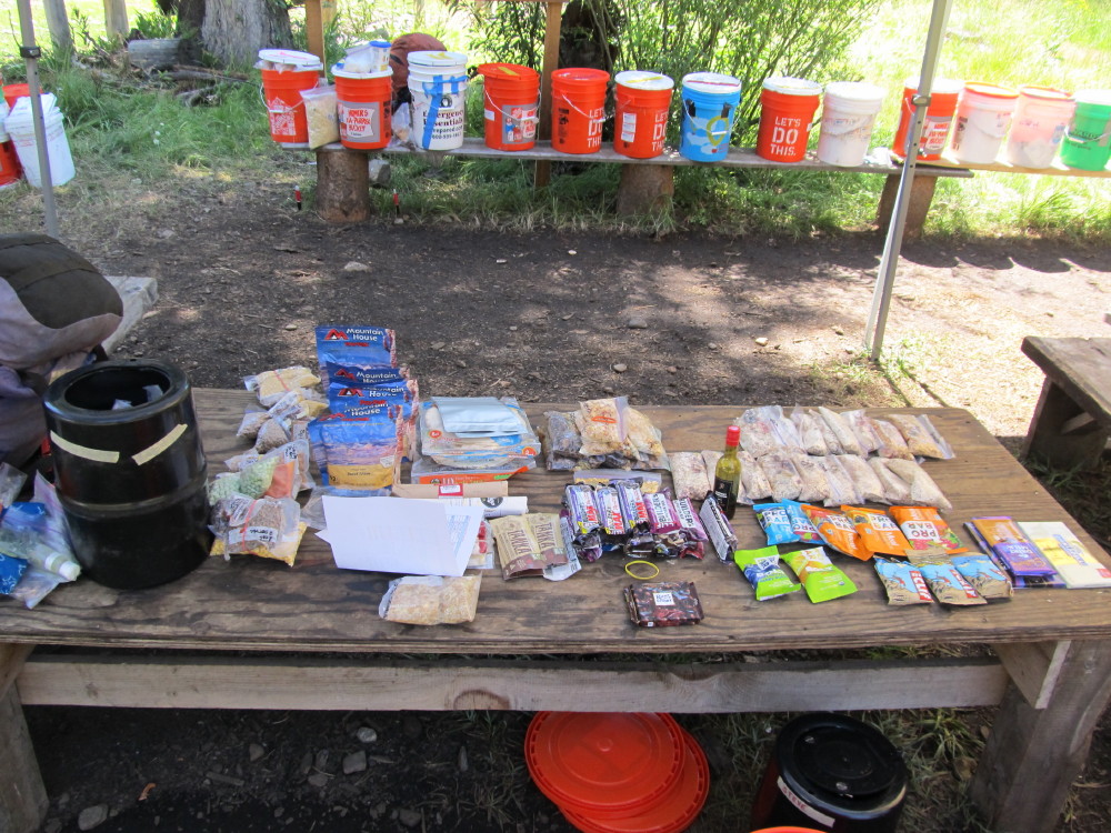Our resupply food laid out at MTR with some of the 20 hiker barrels in the background