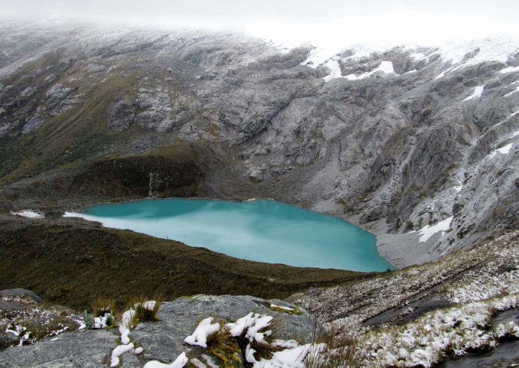 The turquoise waters of Lake Taullicocha are visible at you near Punta Union Pass at 15,617 ft (4,760 m)
