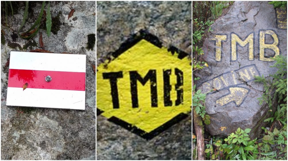 Three TMB signs; white and red strips, yellow diamond and paint on rock
