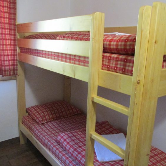 Bunk beds with red checkered bedpreads