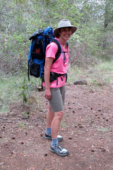 Woman wearing backpack and Altra Lone Peak shoes