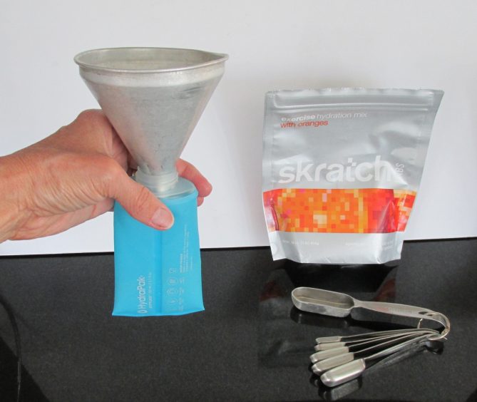 Funnel set in flask to pour drink powder