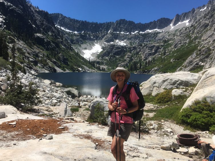Alpine lake surrounded by granite peaks. Author pictured.