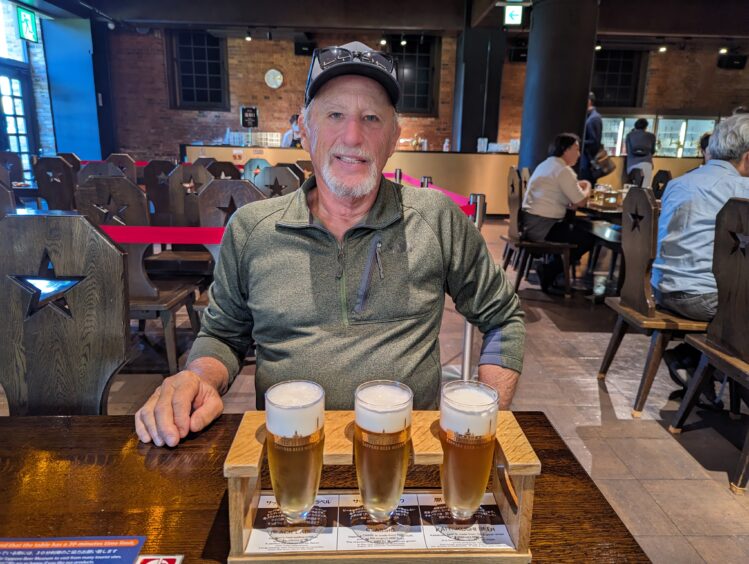 Man sitting behind 3 glasses of beer