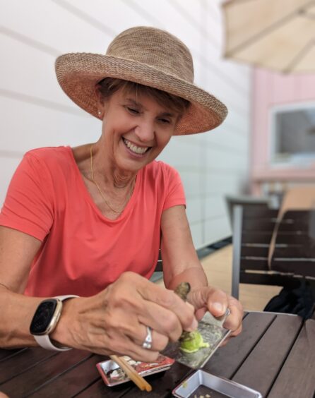 Woman grating fresh green wasabi