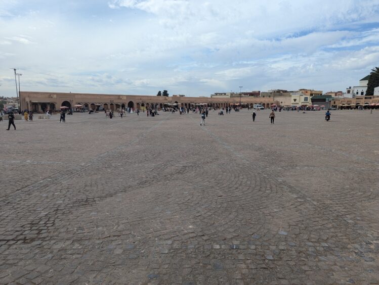 Vast square with a few people scattered about