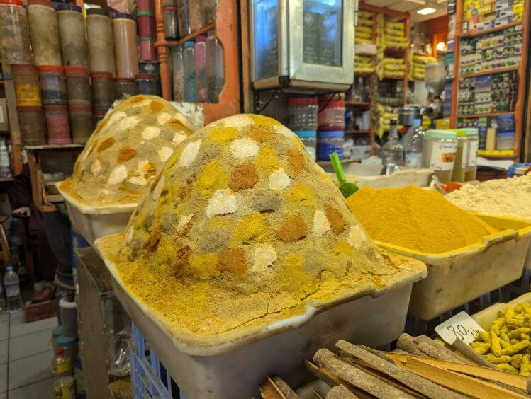 Mound of spices with patchwork of different ochre, yellow and brown colors