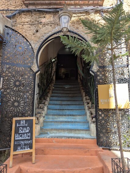 Entrance stairs to hotel with blue steps