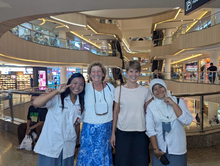 Four women (the author and friend with two Indonesian women) at the mall. 