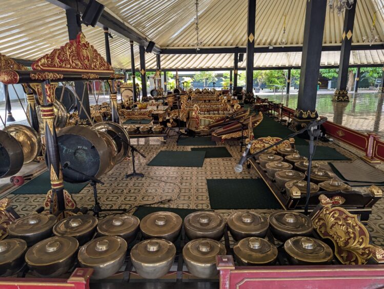 Image shows the many percussive instruments of a full gamelan orchestra.