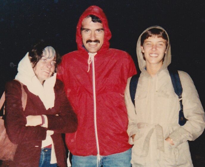A man and two women, including author from decades ago, dressed in street clothing that doesn't look appropriate for climbing a mountain.