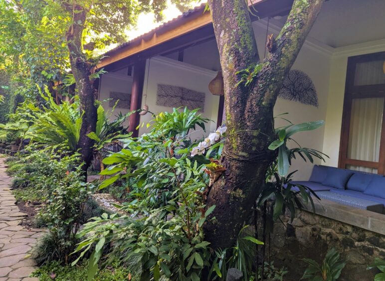 Gardens outside of patios in a block of rooms at Rumah Mertua Heritage Hotel