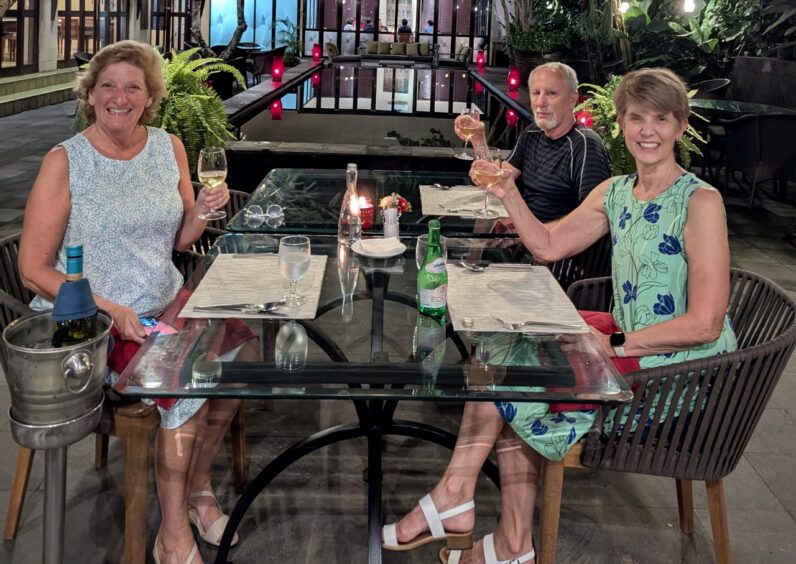 Tha author, friend and husband seated at a restaurant