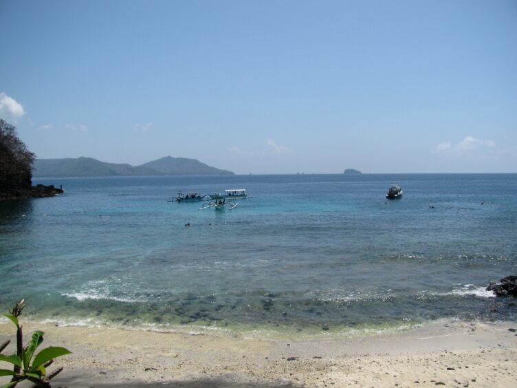Beach with snorkel boats in the background