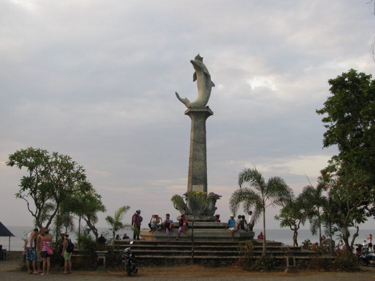 Tall pedestal topped with dolphin structure