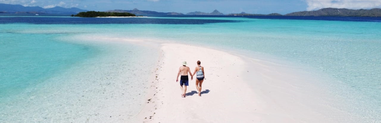 Couple walking on sandbar
