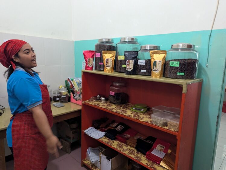 Indonesian woman explaining about how they process coffee beans