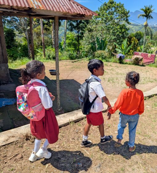 Three children walking to school 